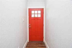 8926 Easthaven Blvd, Houston, TX 77075 - doorway to outside with baseboards and dark wood-style flooring