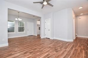 8926 Easthaven Blvd, Houston, TX 77075 - unfurnished living room with ceiling fan with notable chandelier, wood finished floors, and baseboards