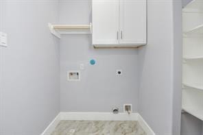 washroom featuring hookup for an electric dryer, baseboards, hookup for a washing machine, hookup for a gas dryer, and cabinet space