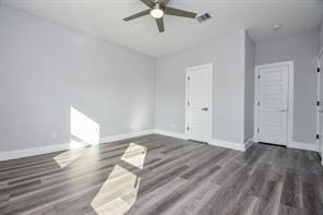 spare room with wood finished floors, baseboards, and ceiling fan