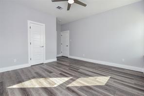 interior space featuring baseboards, wood finished floors, and ceiling fan