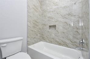 full bathroom featuring toilet and bathtub / shower combination