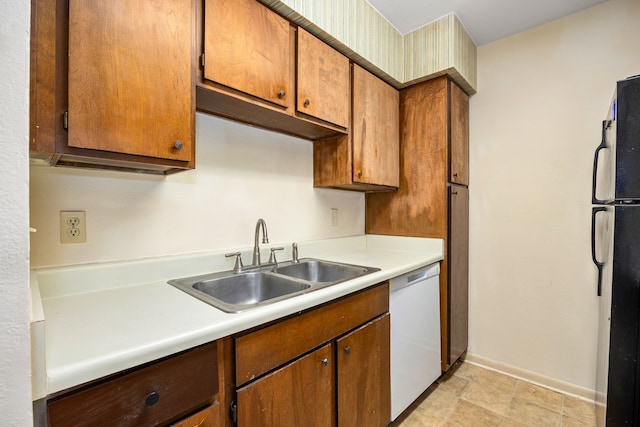 8517 Hearth Dr Unit 31, Houston, TX 77054 - kitchen featuring light countertops, dishwasher, freestanding refrigerator, and a sink