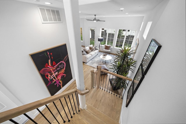 stairway featuring a ceiling fan, wood finished floors, visible vents, and recessed lighting