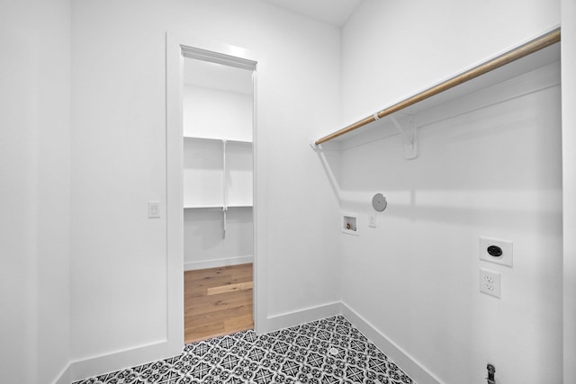 laundry area featuring hookup for an electric dryer, washer hookup, baseboards, and laundry area