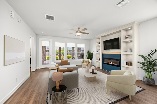 28928 Autumn Shore Dr, Fulshear, TX 77441 - living area featuring wood finished floors, a fireplace, baseboards, and a ceiling fan