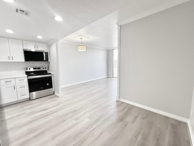 kitchen with ornamental molding, white cabinetry, stainless steel appliances, and decorative backsplash