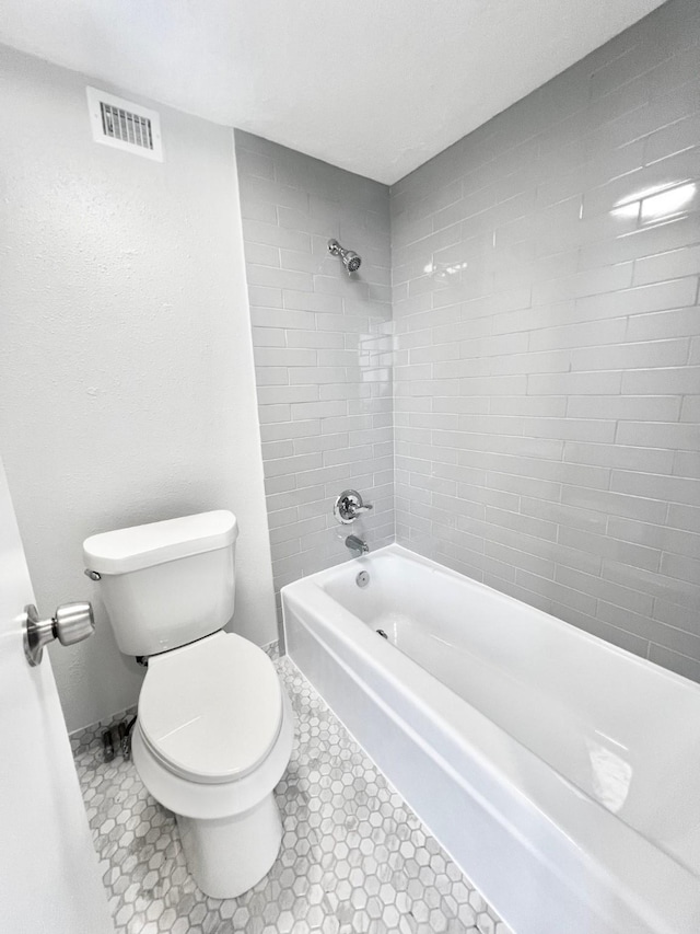 full bath featuring visible vents, toilet, and bathtub / shower combination