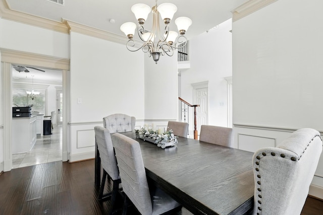 16311 Perry Pass Ct, Spring, TX 77379 - dining room with a chandelier, crown molding, a wainscoted wall, wood finished floors, and a decorative wall