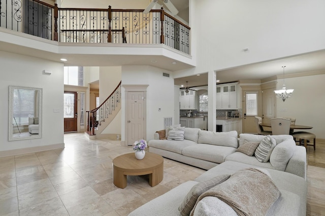 16311 Perry Pass Ct, Spring, TX 77379 - living room with a chandelier, plenty of natural light, stairs, a high ceiling, and baseboards