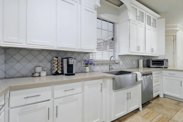 16311 Perry Pass Ct, Spring, TX 77379 - kitchen with a sink, stainless steel dishwasher, decorative backsplash, white cabinets, and light countertops
