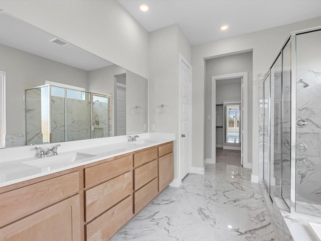 bathroom featuring recessed lighting, marble finish floor, a marble finish shower, and a sink
