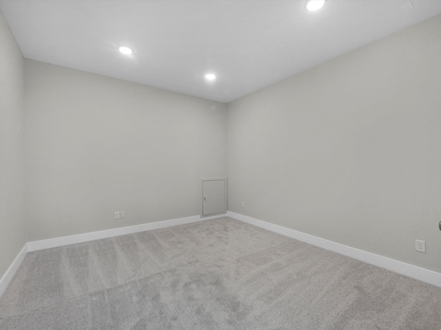 carpeted empty room with baseboards and recessed lighting