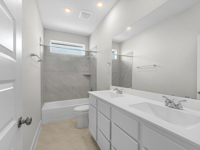 bathroom featuring shower / bath combination, toilet, a sink, and visible vents