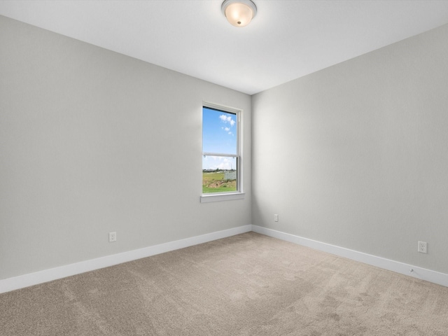 empty room with light carpet and baseboards