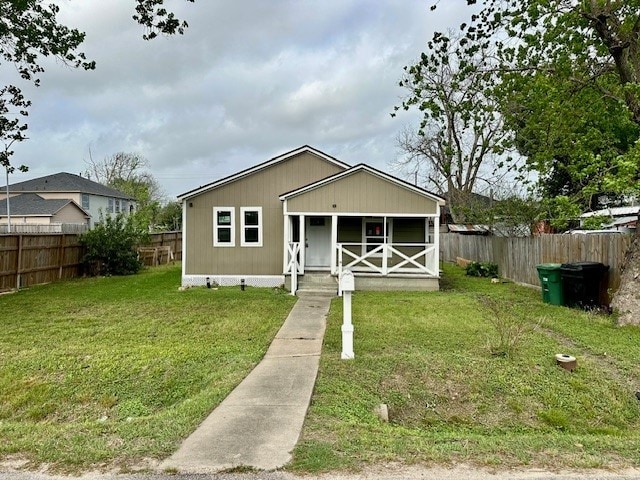 8230 Woodward St, Houston, TX 77051 - bungalow featuring fence, a porch, and a front lawn