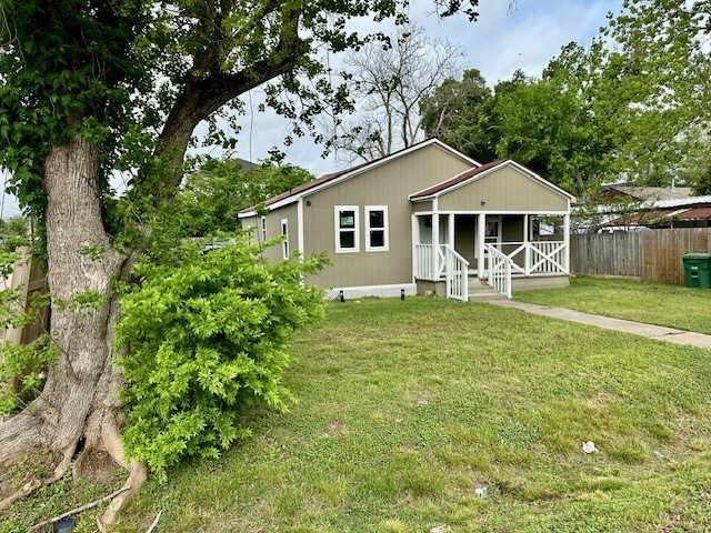 8230 Woodward St, Houston, TX 77051 - view of front facade featuring a porch, a front yard, and fence