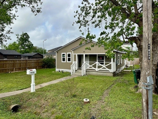8230 Woodward St, Houston, TX 77051 - bungalow-style home featuring fence, covered porch, and a front yard
