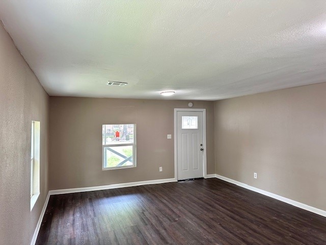 8230 Woodward St, Houston, TX 77051 - entryway featuring visible vents, dark wood-style flooring, and baseboards
