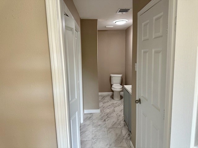 8230 Woodward St, Houston, TX 77051 - bathroom with visible vents, baseboards, toilet, vanity, and marble finish floor