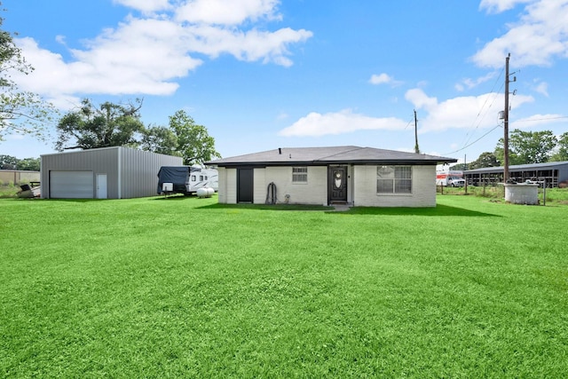 8911 Carraway Ln, Magnolia, TX 77354 - back of house with a lawn, an outbuilding, and a detached garage