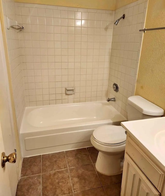 full bathroom featuring tile patterned flooring, shower / washtub combination, a textured wall, toilet, and vanity