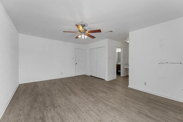 interior space with wood finished floors, visible vents, and baseboards