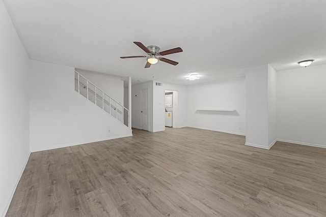 11887 Algonquin Dr, Houston, TX 77089 - unfurnished living room with a ceiling fan, wood finished floors, baseboards, and stairway