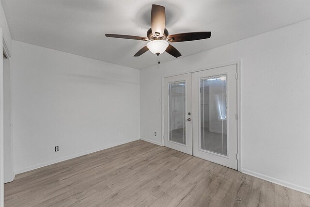 unfurnished room with ceiling fan, baseboards, french doors, and light wood-style floors