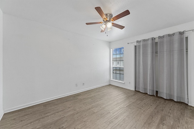 11887 Algonquin Dr, Houston, TX 77089 - unfurnished bedroom featuring wood finished floors, baseboards, and a ceiling fan