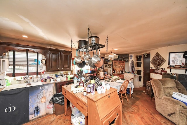 16777 Stinson Ln, Montgomery, TX 77316 - kitchen with recessed lighting, light countertops, light wood-style floors, dark brown cabinetry, and open floor plan