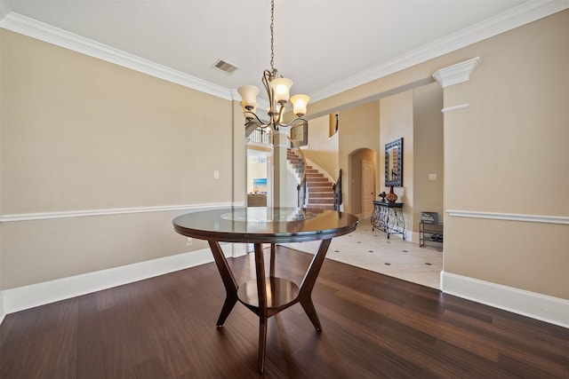 514 Whitney Oaks Ln, Stafford, TX 77477 - dining area with wood finished floors, visible vents, arched walkways, and crown molding