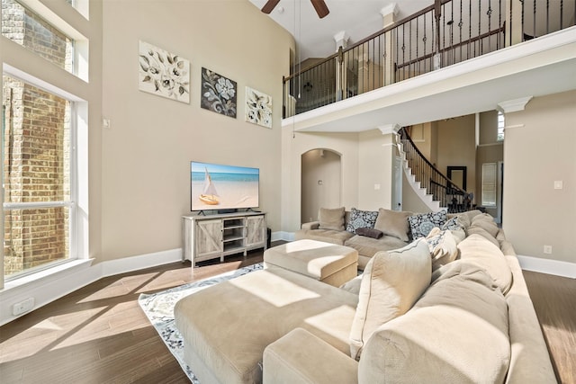 514 Whitney Oaks Ln, Stafford, TX 77477 - living area featuring wood finished floors, a towering ceiling, stairs, and ceiling fan