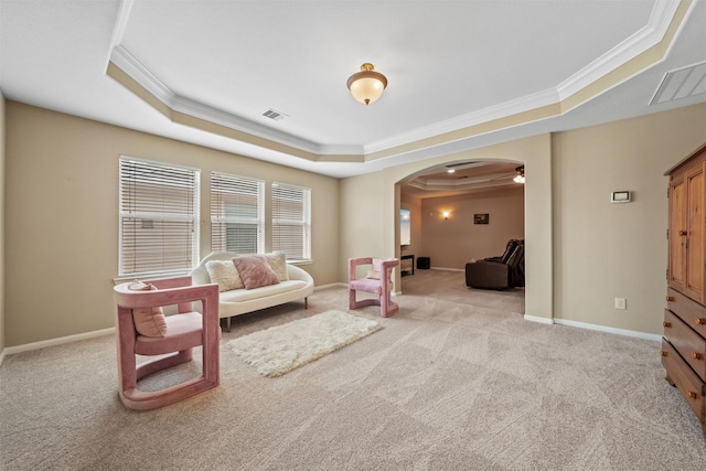 514 Whitney Oaks Ln, Stafford, TX 77477 - living area with carpet, a tray ceiling, visible vents, ornamental molding, and arched walkways