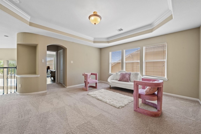 514 Whitney Oaks Ln, Stafford, TX 77477 - living area with a tray ceiling, arched walkways, visible vents, carpet, and crown molding