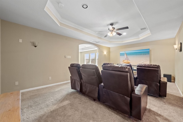 514 Whitney Oaks Ln, Stafford, TX 77477 - home theater featuring a raised ceiling, arched walkways, carpet floors, crown molding, and ceiling fan