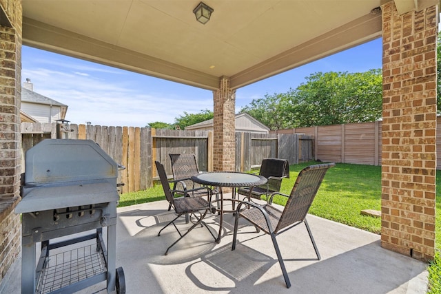 514 Whitney Oaks Ln, Stafford, TX 77477 - view of patio / terrace featuring outdoor dining area, a fenced backyard, and area for grilling