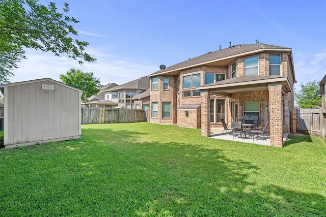 514 Whitney Oaks Ln, Stafford, TX 77477 - back of property with a fenced backyard, a storage shed, a yard, a patio, and brick siding