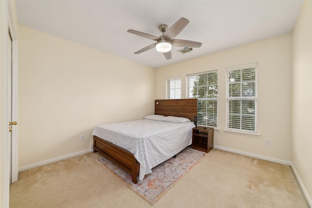 carpeted bedroom featuring visible vents, a ceiling fan, and baseboards