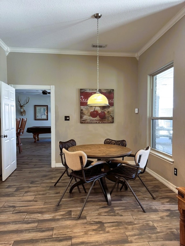 dining area featuring baseboards, visible vents, ornamental molding, and dark wood-type flooring