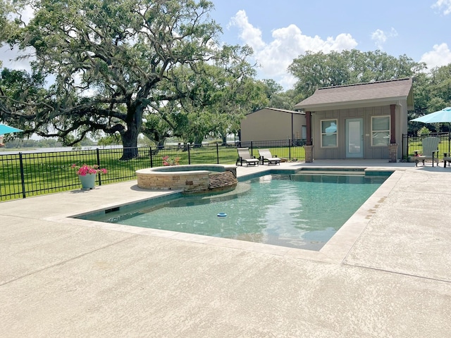 view of swimming pool featuring a patio, fence, and a pool with connected hot tub