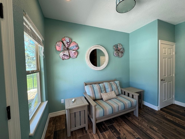living area with wood finished floors and baseboards