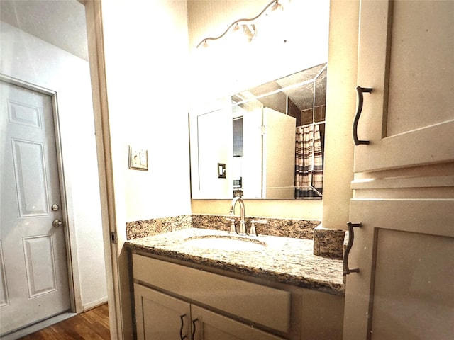 bathroom with vanity and wood finished floors