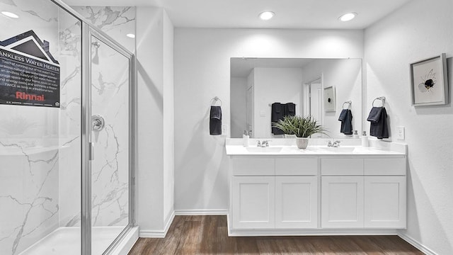 2707 Misty Elm Ln, Rosenberg, TX 77469 - bathroom with a marble finish shower, wood finished floors, double vanity, recessed lighting, and baseboards