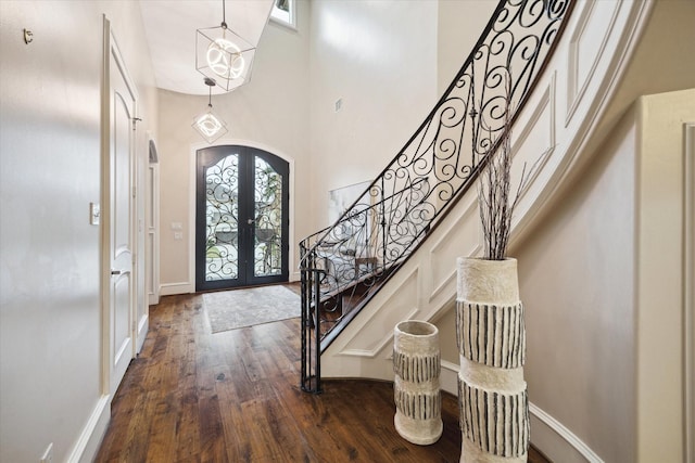3822 Drummond St, Houston, TX 77025 - entrance foyer with french doors, arched walkways, dark wood finished floors, stairs, and a high ceiling