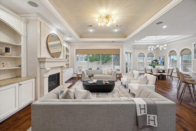 3822 Drummond St, Houston, TX 77025 - living room featuring a chandelier, a tray ceiling, ornamental molding, and dark wood-style flooring