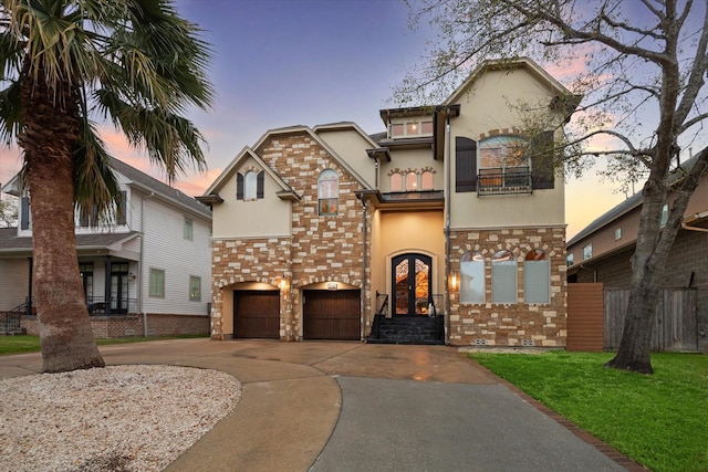 3822 Drummond St, Houston, TX 77025 - view of front facade featuring stucco siding, a balcony, an attached garage, driveway, and french doors