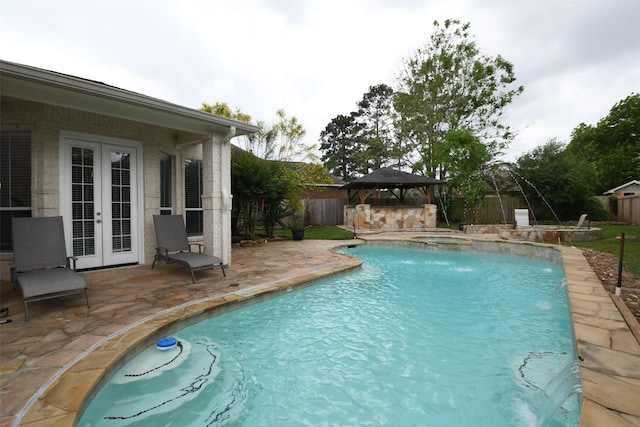 view of swimming pool featuring french doors, a patio area, a gazebo, a fenced in pool, and a fenced backyard