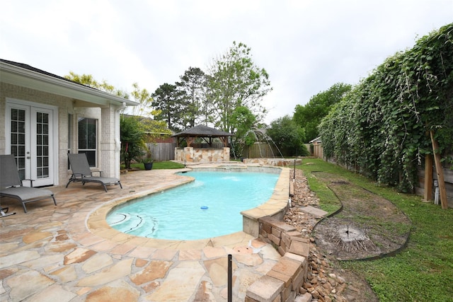 view of swimming pool with a fenced backyard, french doors, a fenced in pool, a patio area, and a gazebo