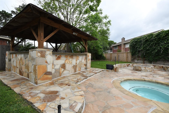 7414 Regency Pl, Spring, TX 77379 - view of patio with fence, a gazebo, and an in ground hot tub